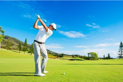 Golfer hitting a shot on a bright sunny day, symbolizing focus and patience in tournament golf.